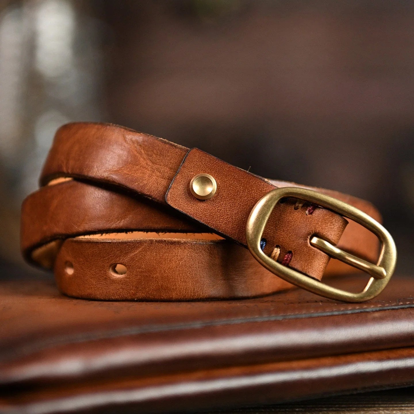 Women's distressed cowhide belt in cognac brown