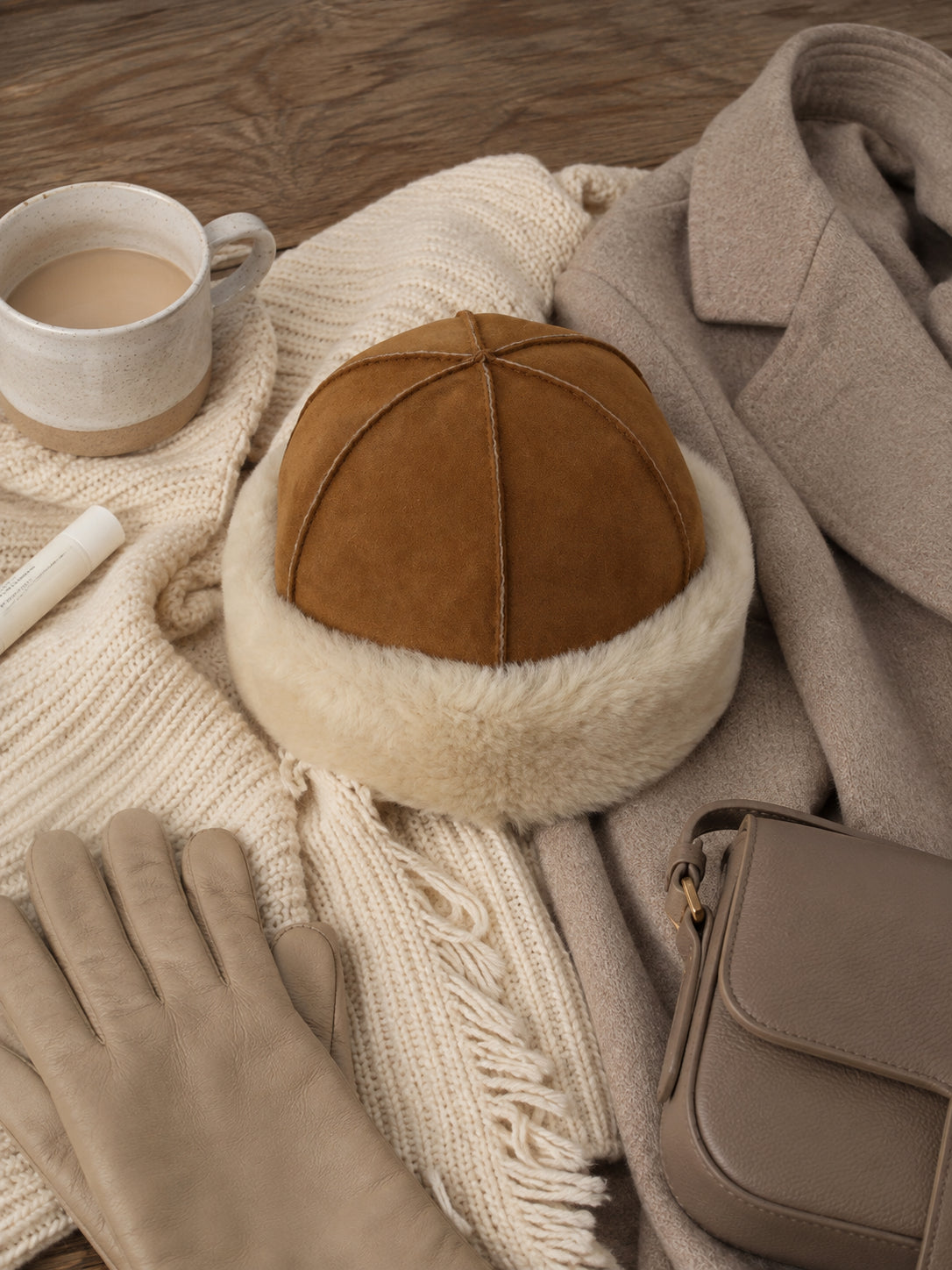 Camel and ivory wool shearling winter hat styled with neutral winter layers