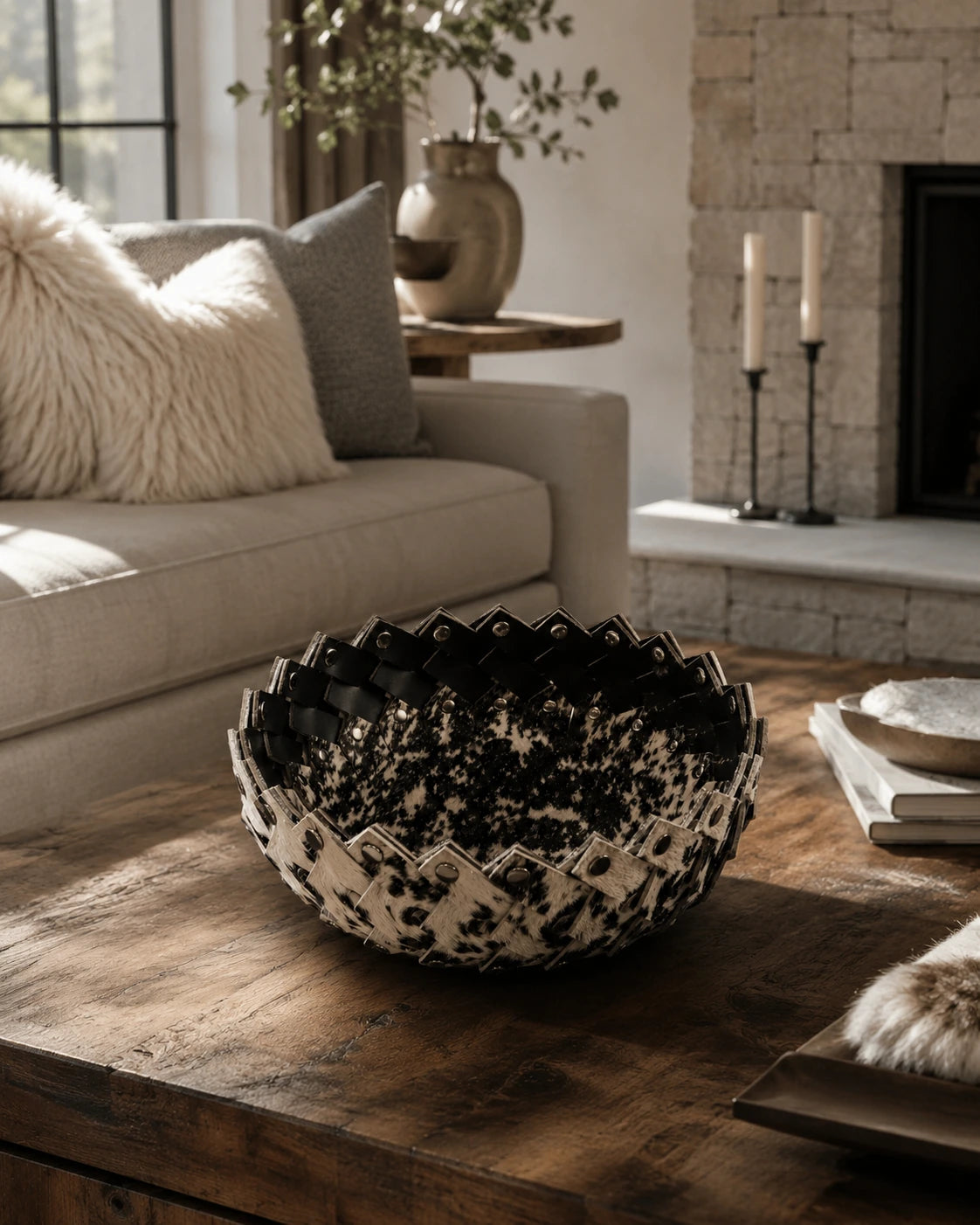 Black and ivory genuine cowhide catchall bowl styled on a wood coffee table