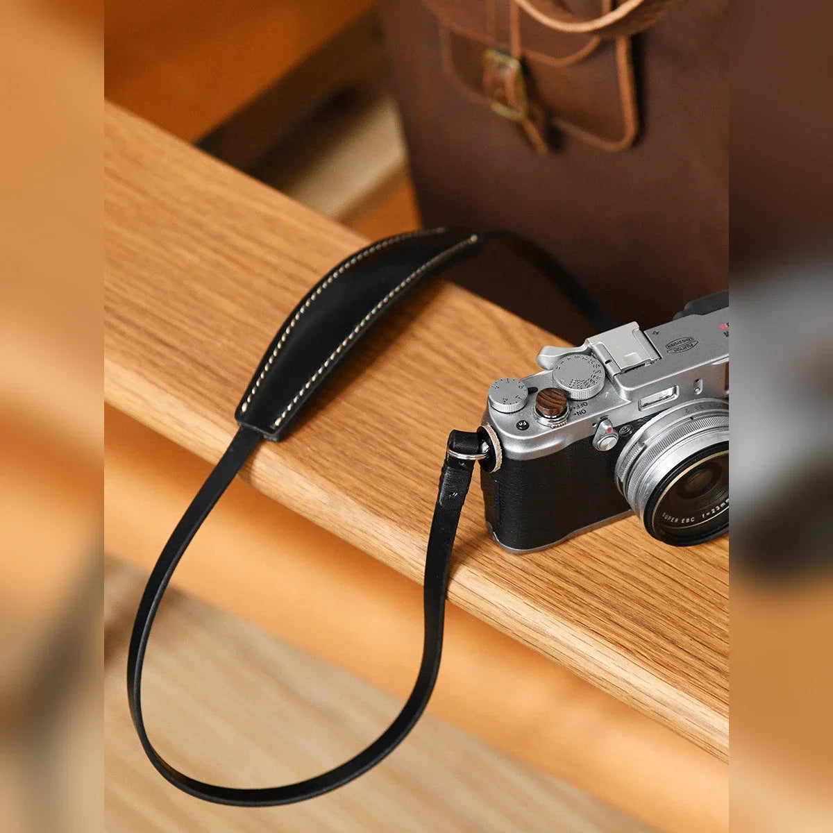 Black cowhide leather camera shoulder strap with mirrorless camera