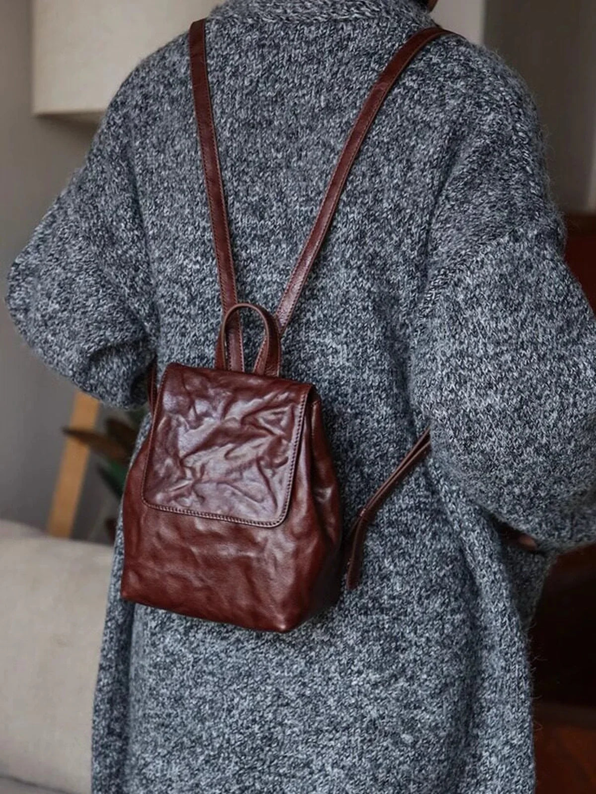 Coffee-brown mini leather backpack shown at wearable scale