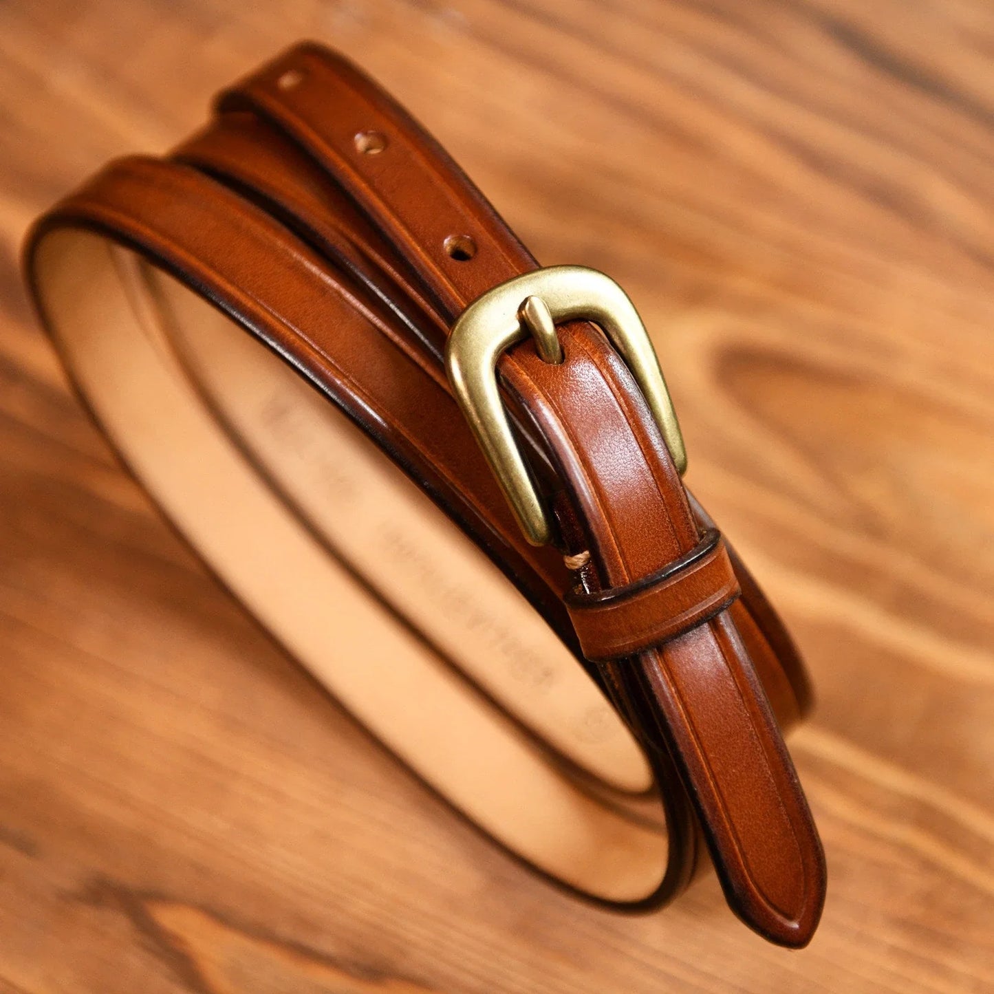 Brown leather slim belt surface and edge detail