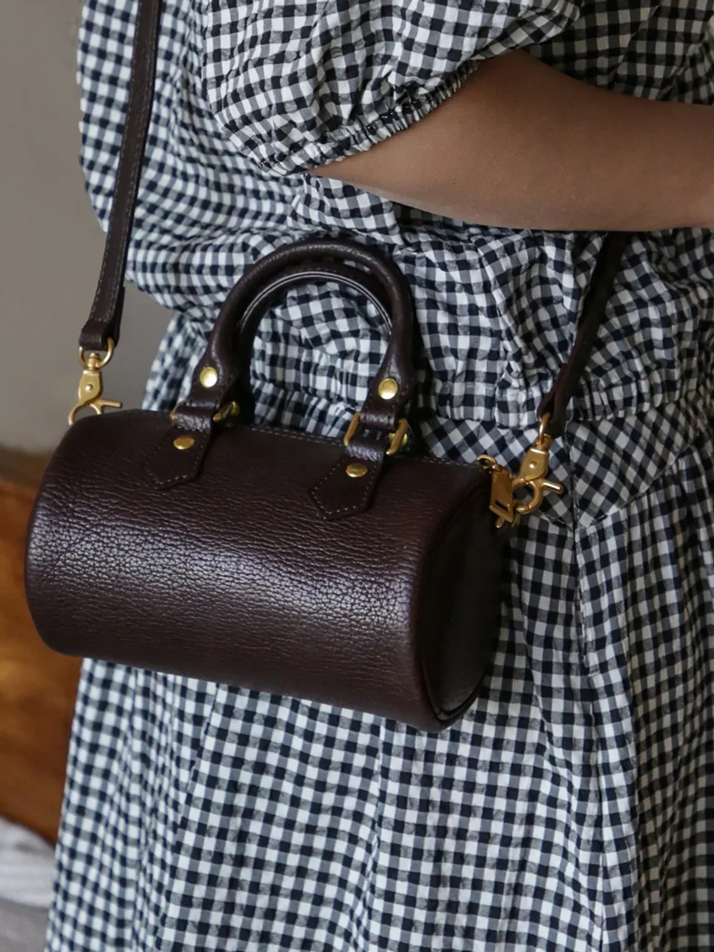 Close view of coffee brown pebbled leather and alloy hardware
