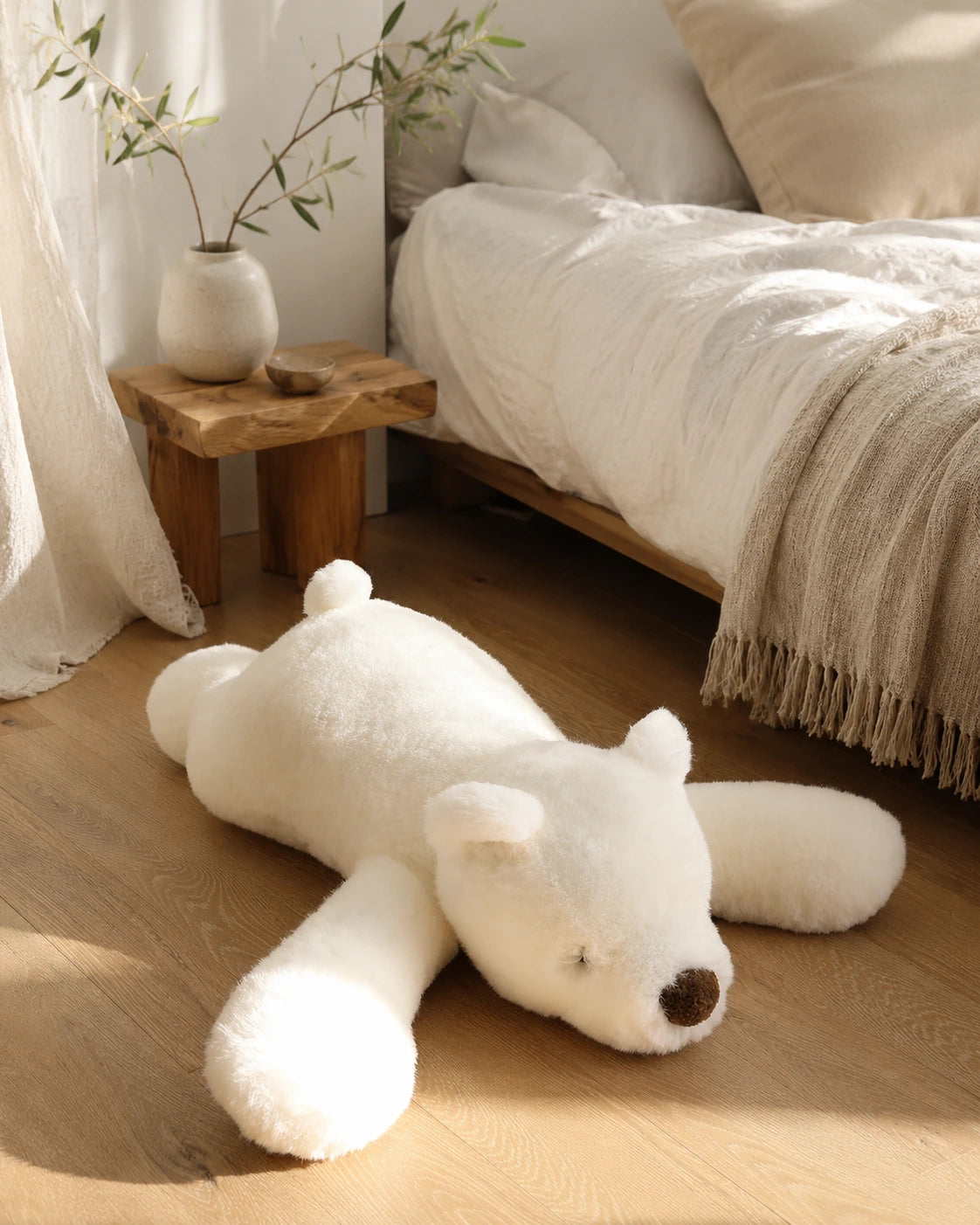 Polar Bear genuine natural fur floor cushion styled beside a neutral bed