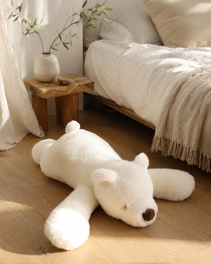 Polar Bear genuine natural fur floor cushion styled beside a neutral bed