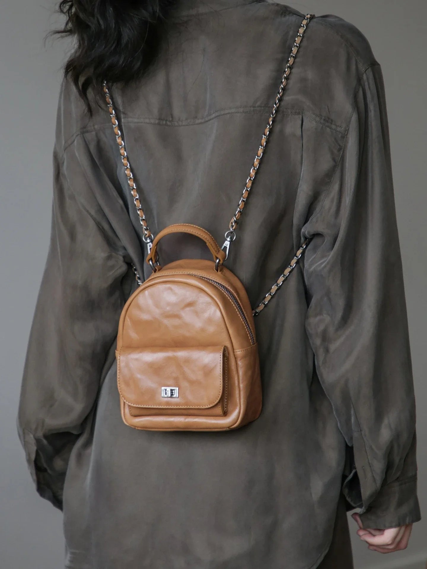 Chestnut brown vegetable-tanned leather mini backpack worn on the back