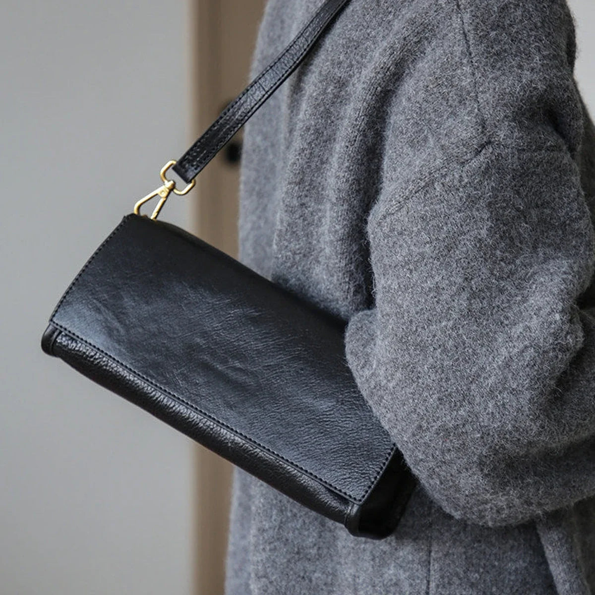 Black leather shoulder bag with a classic strap