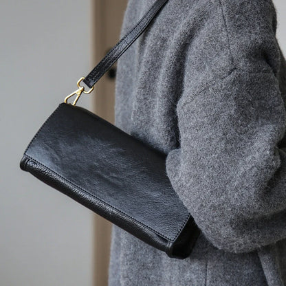 Black leather shoulder bag with a classic strap