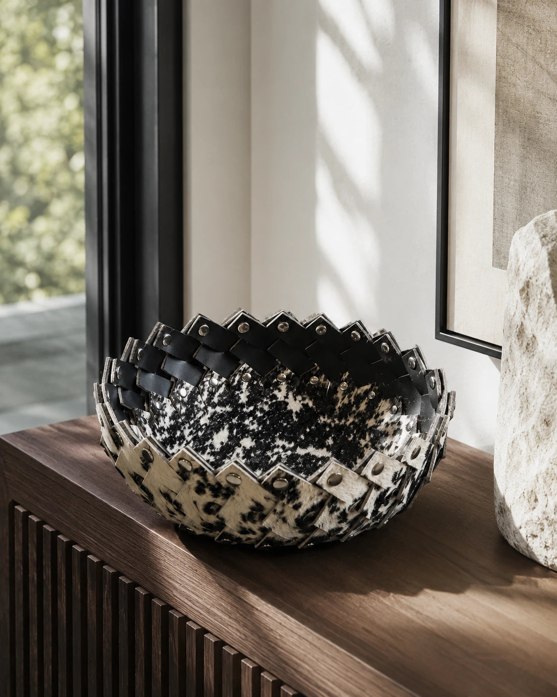 Black and ivory genuine cowhide decorative bowl styled on a console table