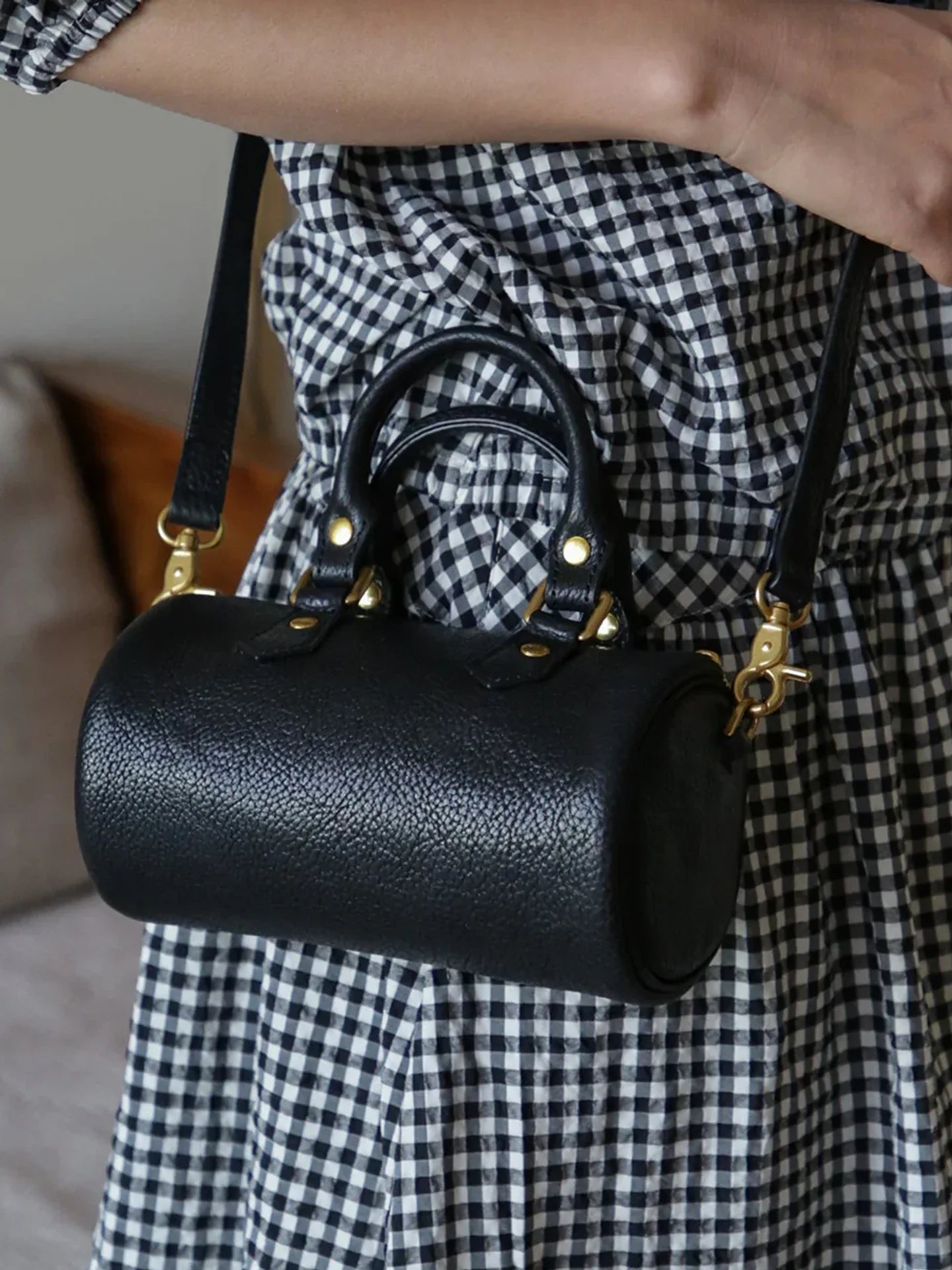 Close view of black pebbled leather and alloy hardware