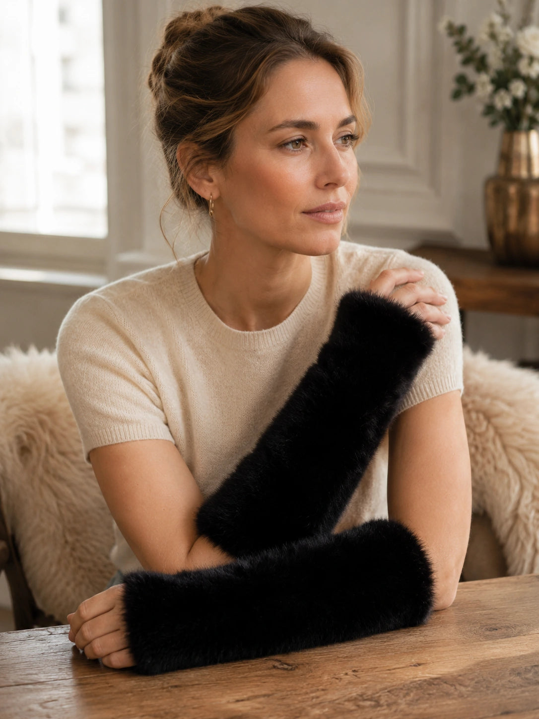 Black mink fur fingerless arm warmers close-up on the hands and forearms