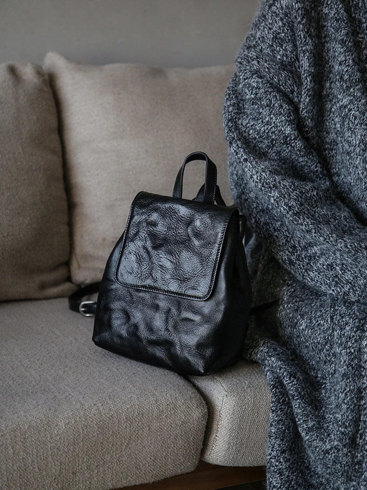 Black vegetable-tanned cowhide mini backpack in a quiet interior