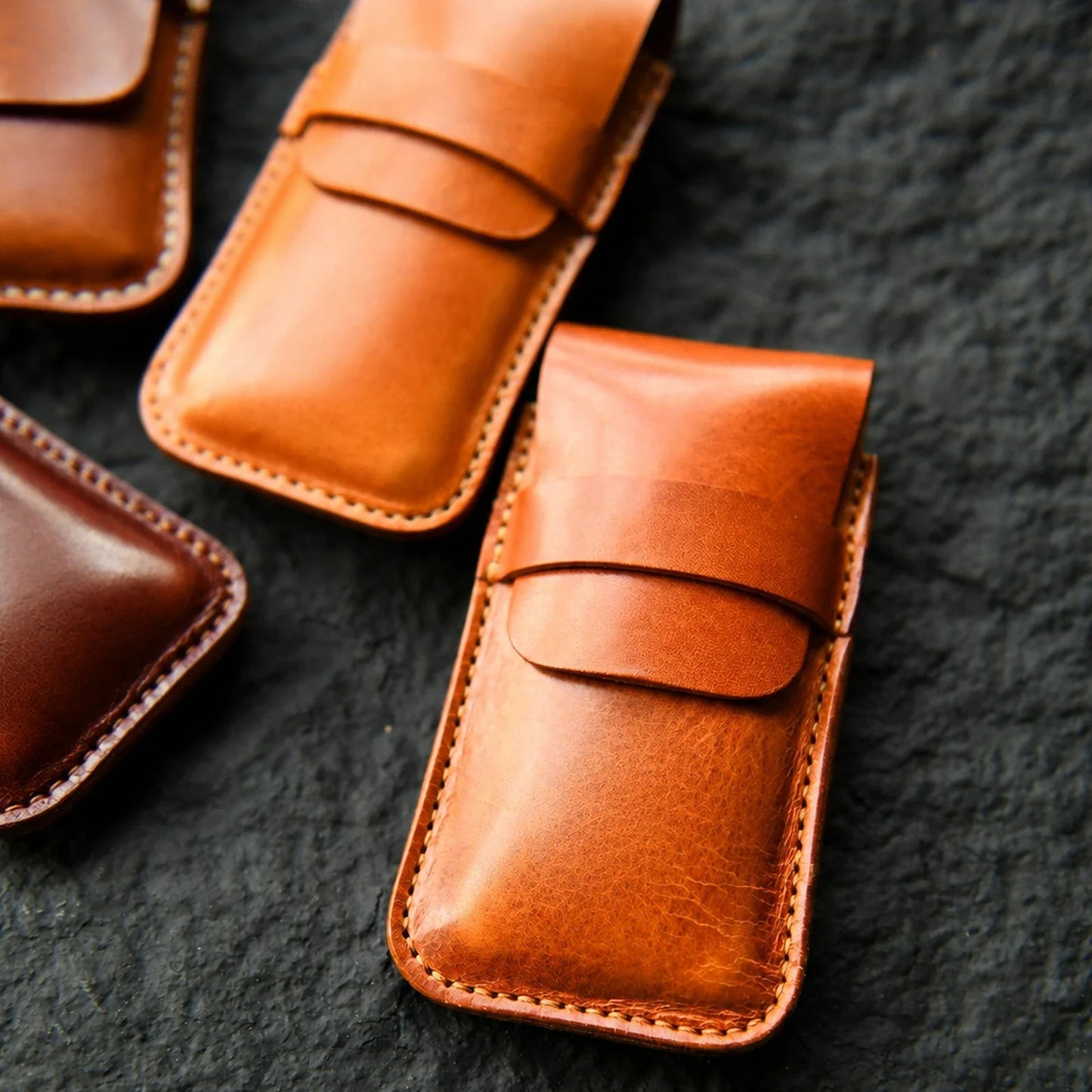 Clean leather watch pouch collection in warm brown tones