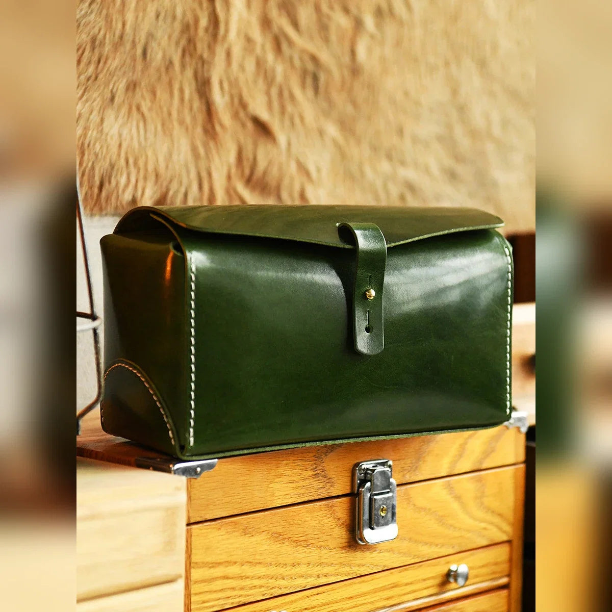Green cowhide travel case in a tea-table setting