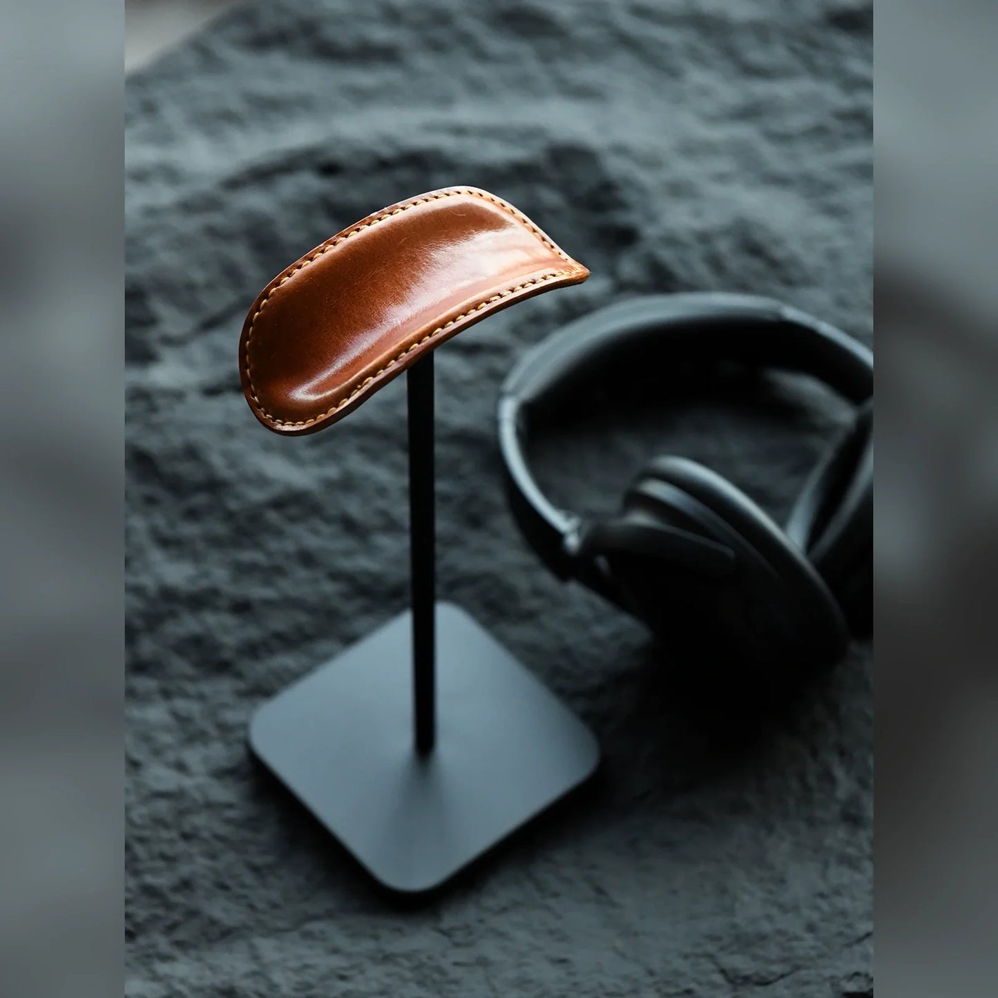 Tan cowhide and black metal headphone stand with headphones