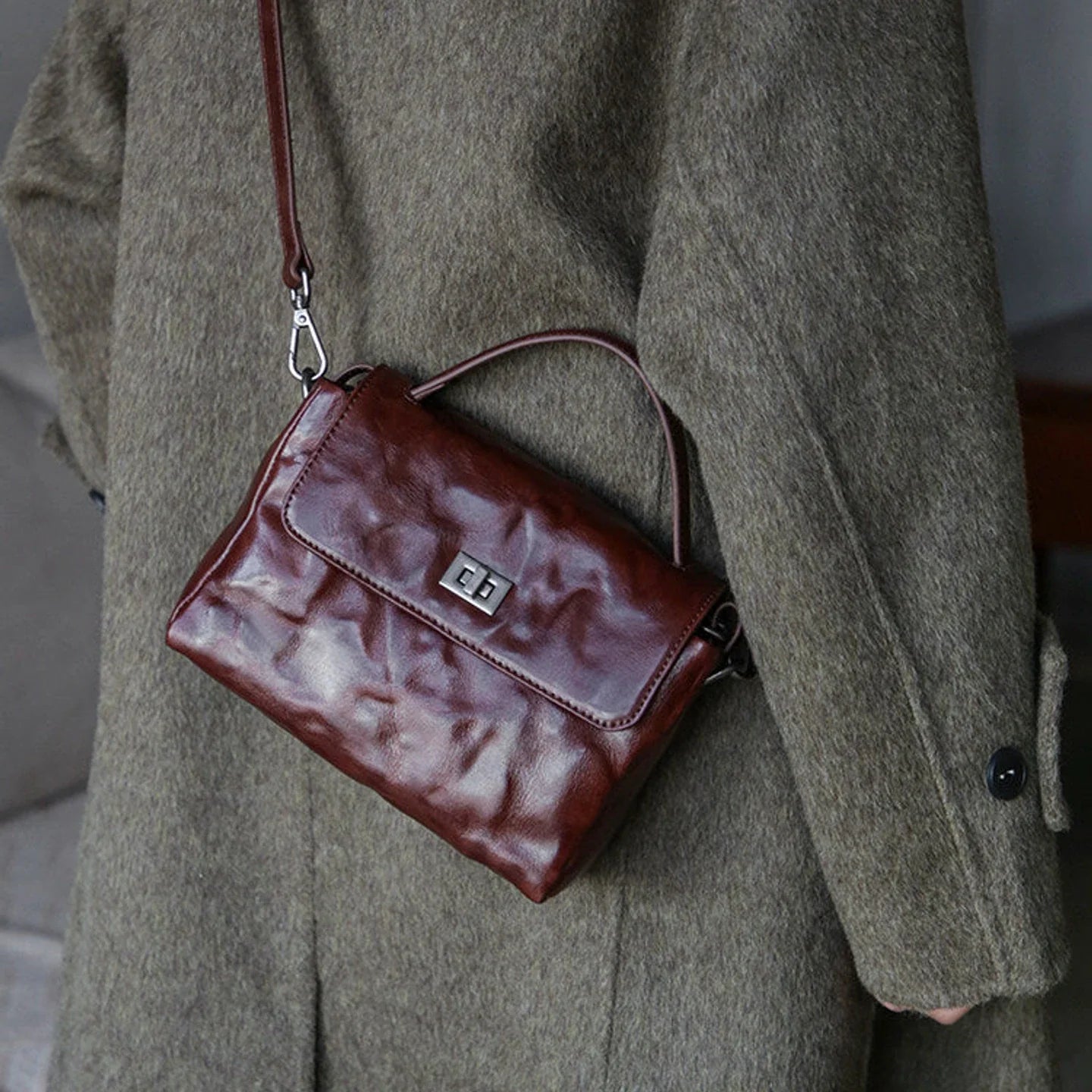 Chestnut brown leather satchel shown from a side angle