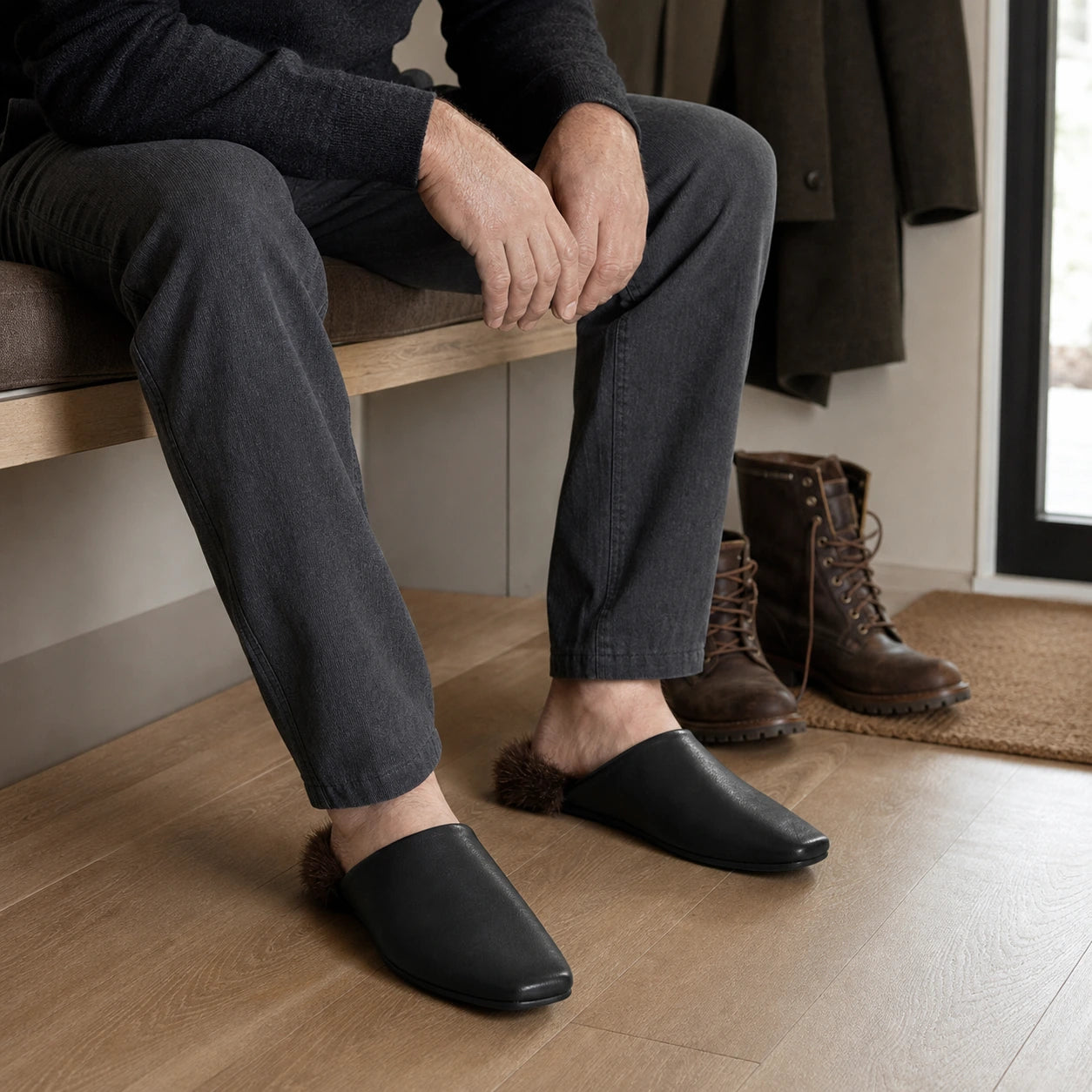 Black mink fur-trim mule slippers worn by an adult man in a dry American entryway