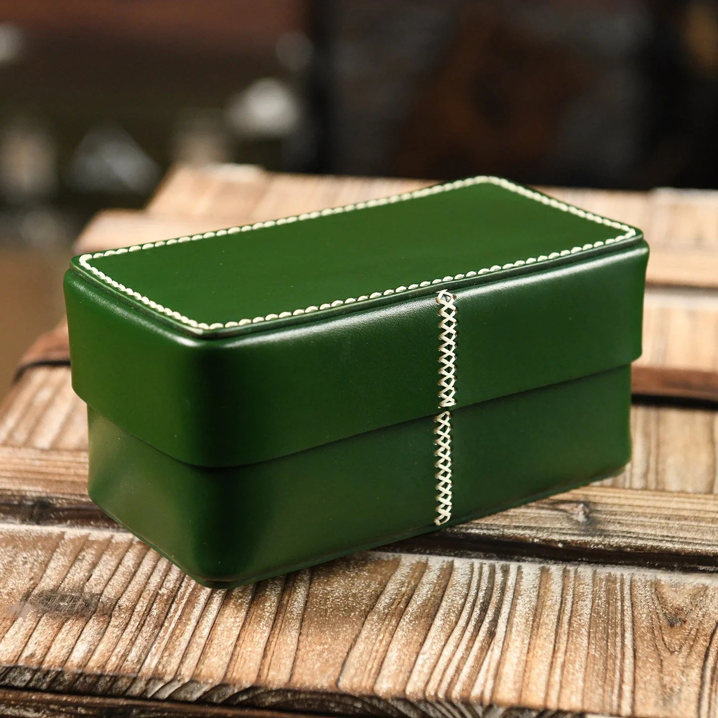 Green handcrafted leather storage box with contrast stitching