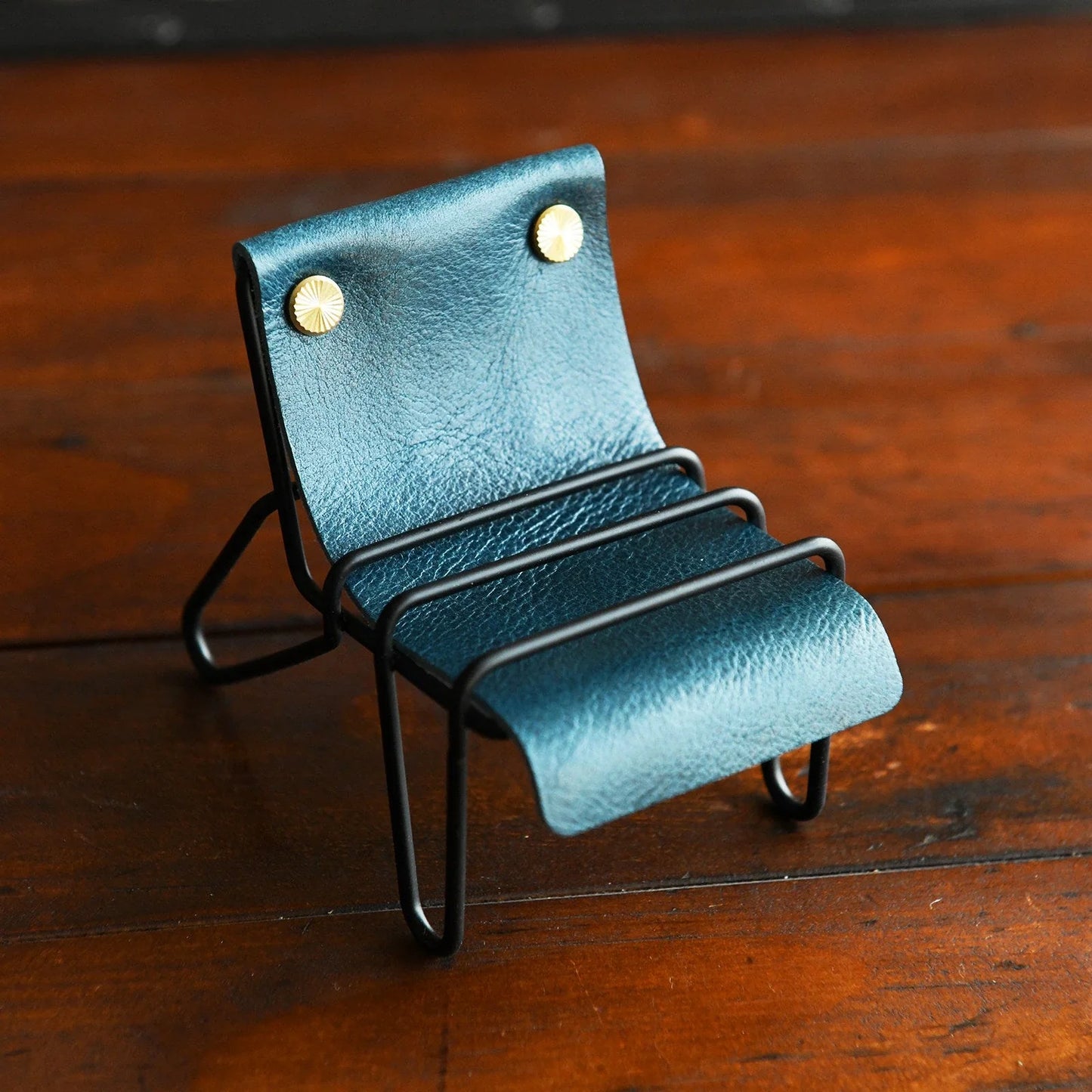 Peacock blue leather phone stand with black frame