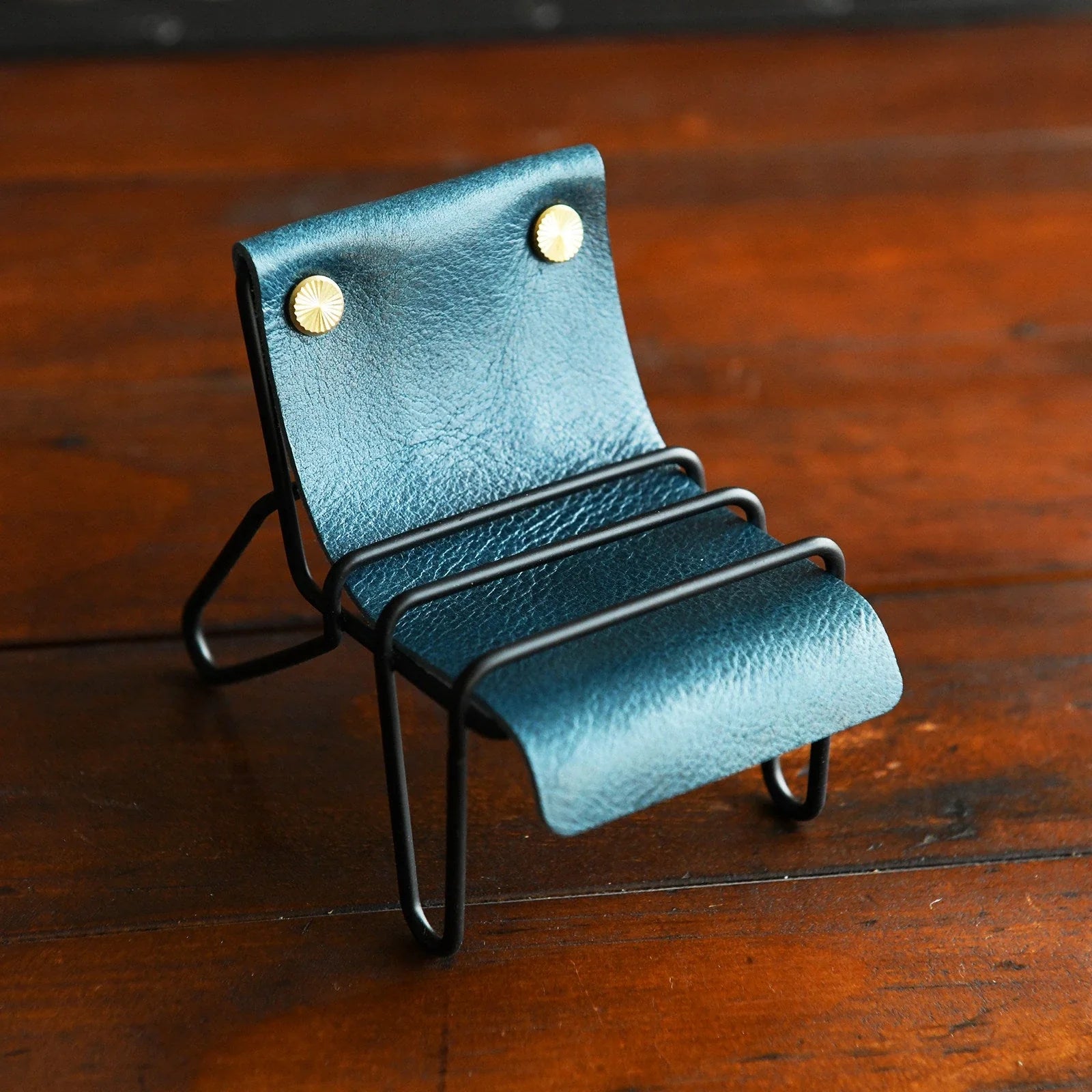 Peacock blue leather phone stand with black frame