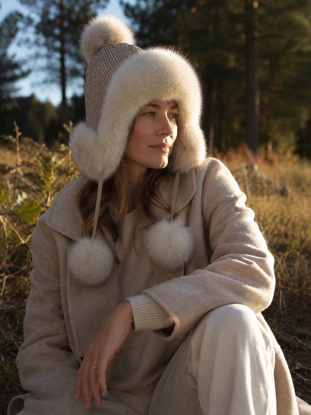 Ivory White genuine fox fur earflap hat styled for a winter walk