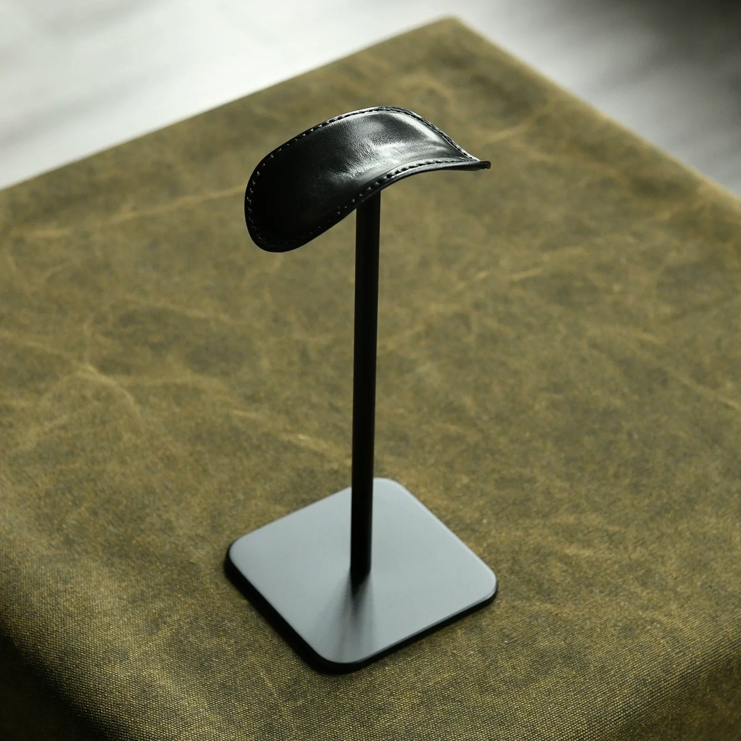 Black cowhide and silver metal headphone stand