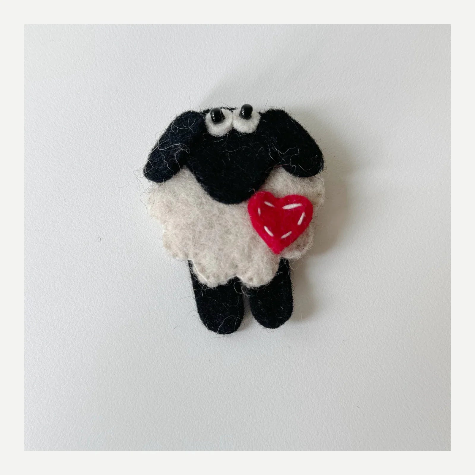 Black and white sheep handmade wool felt brooch with red heart
