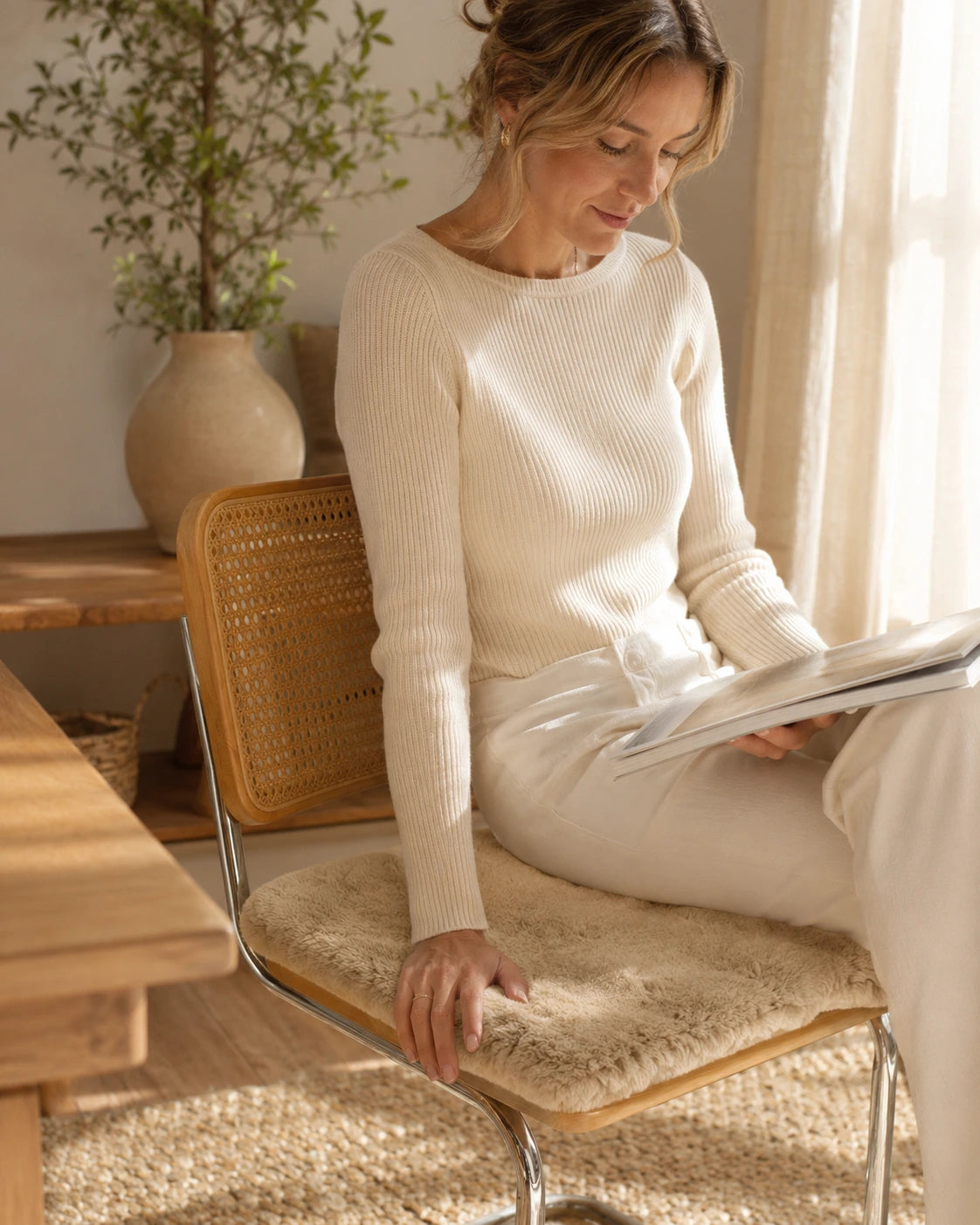 Camel short-pile sheepskin chair pad used for seated reading and laptop work