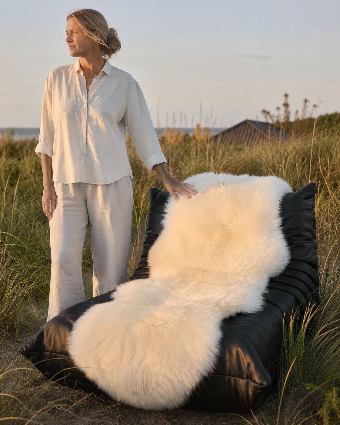 Cream genuine Australian sheepskin rug styled on an outdoor reading chair