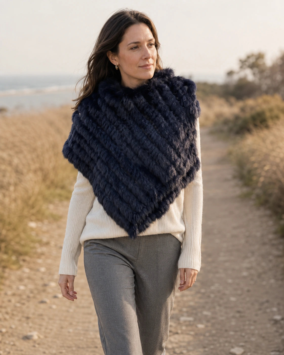 Navy blue rabbit fur knit poncho worn on a dry early-fall walk