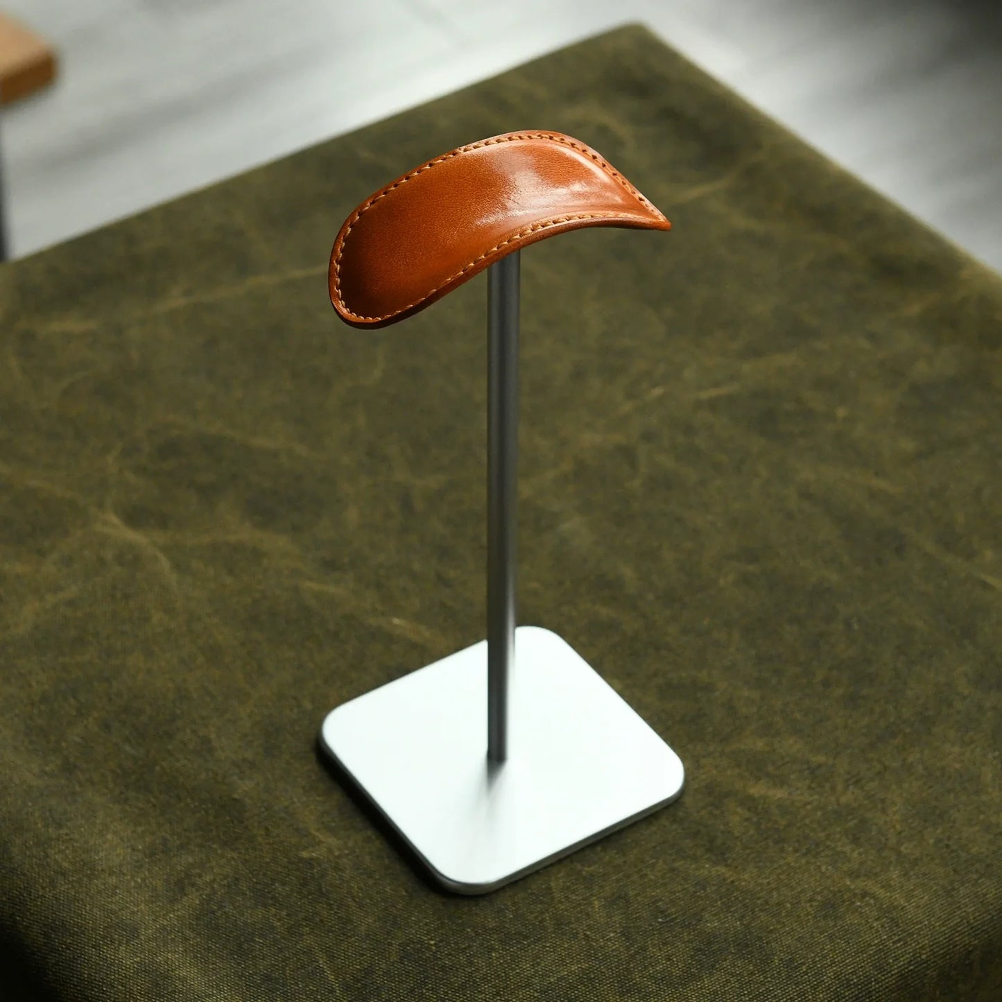 Tan cowhide and silver metal headphone stand