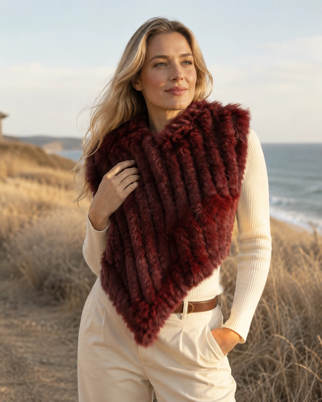 Burgundy rabbit fur knit poncho worn outdoors in dry fall weather