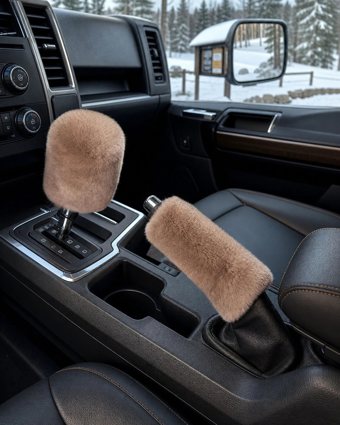 Khaki Rex rabbit fur gear shift and handbrake covers styled in a parked truck at a winter trailhead