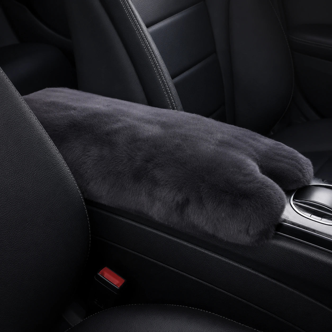 Dark gray genuine Rex rabbit fur center console armrest pad installed in a black car interior