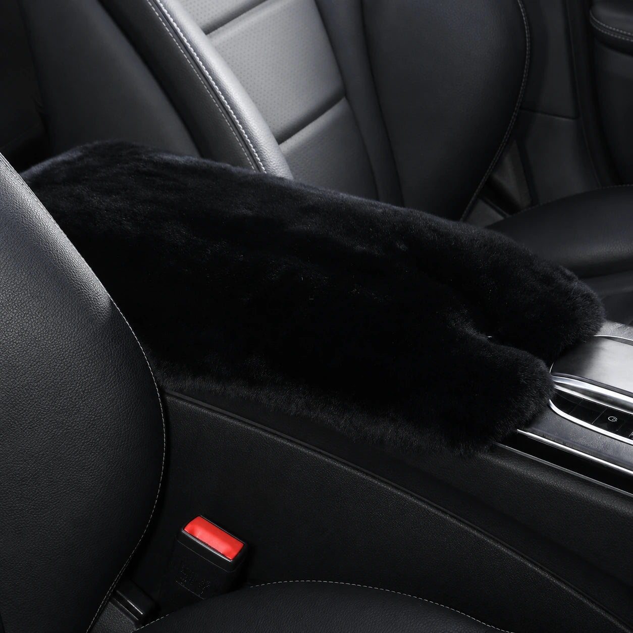 Jet black genuine Rex rabbit fur center console armrest pad installed in a black car interior