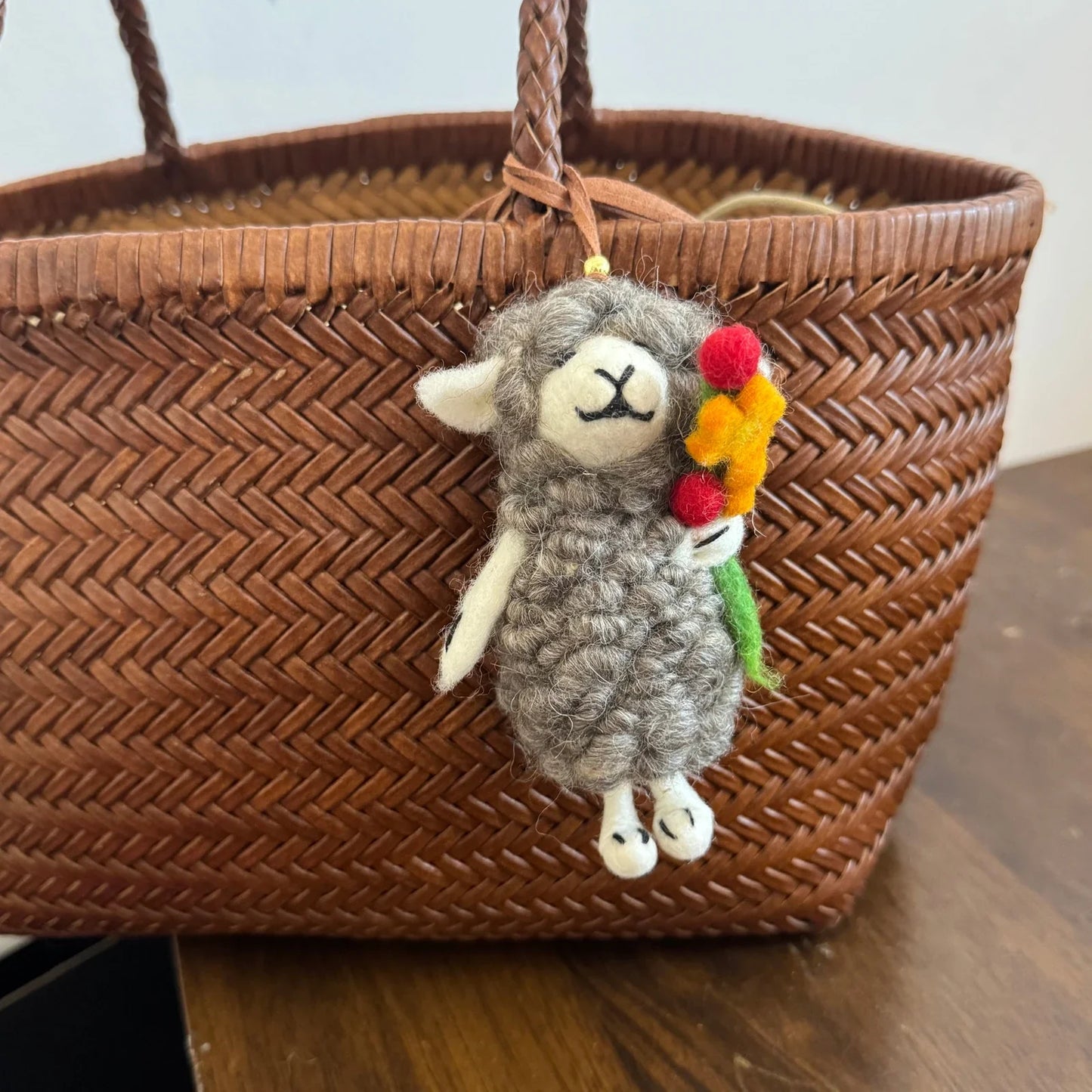 Handmade wool felt sheep bag charm – blue flower hugging sheep