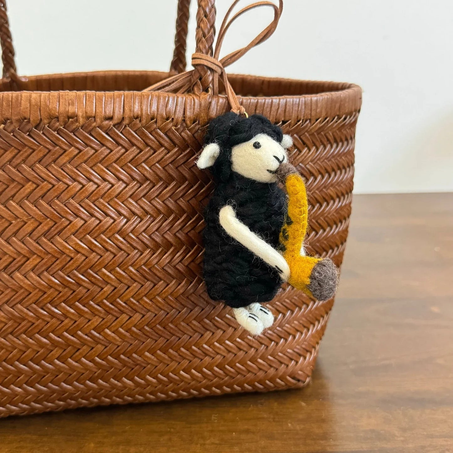 Handmade wool felt sheep bag charm – black sheep with saxophone