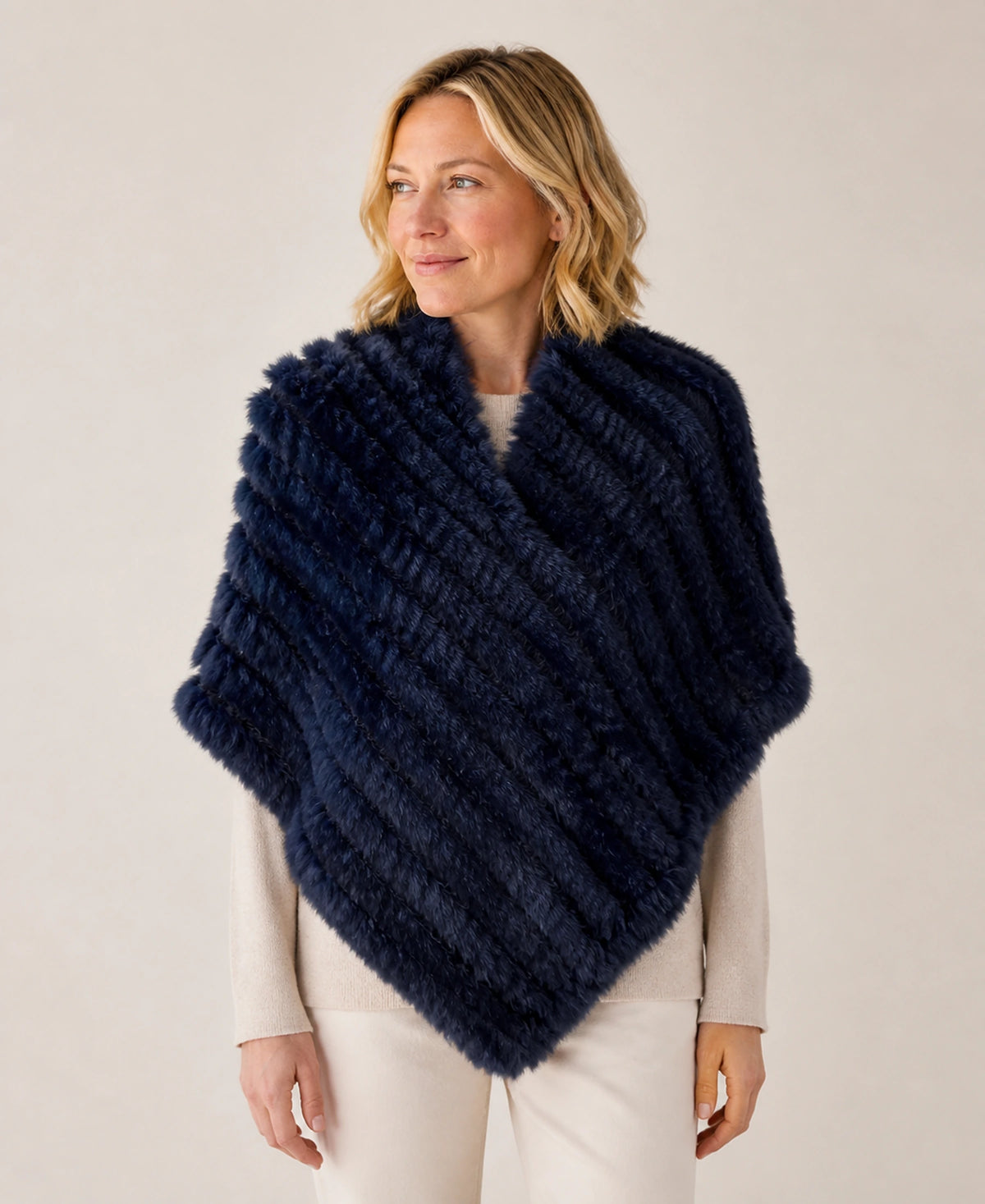 Handwoven Genuine Rabbit Fur Triangle Poncho – Collar Style: Raccoon Fur Collar | Color: Navy Blue on-model lifestyle image
