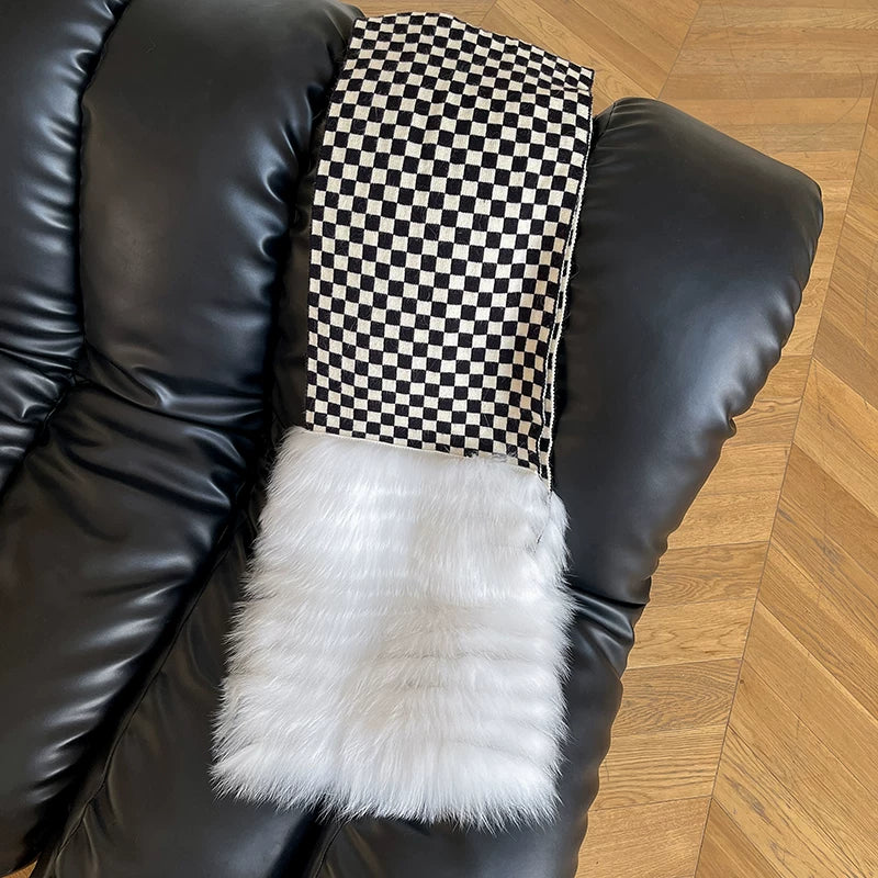 Black-and-white checkerboard fox fur scarf displayed on a black chair, square product detail