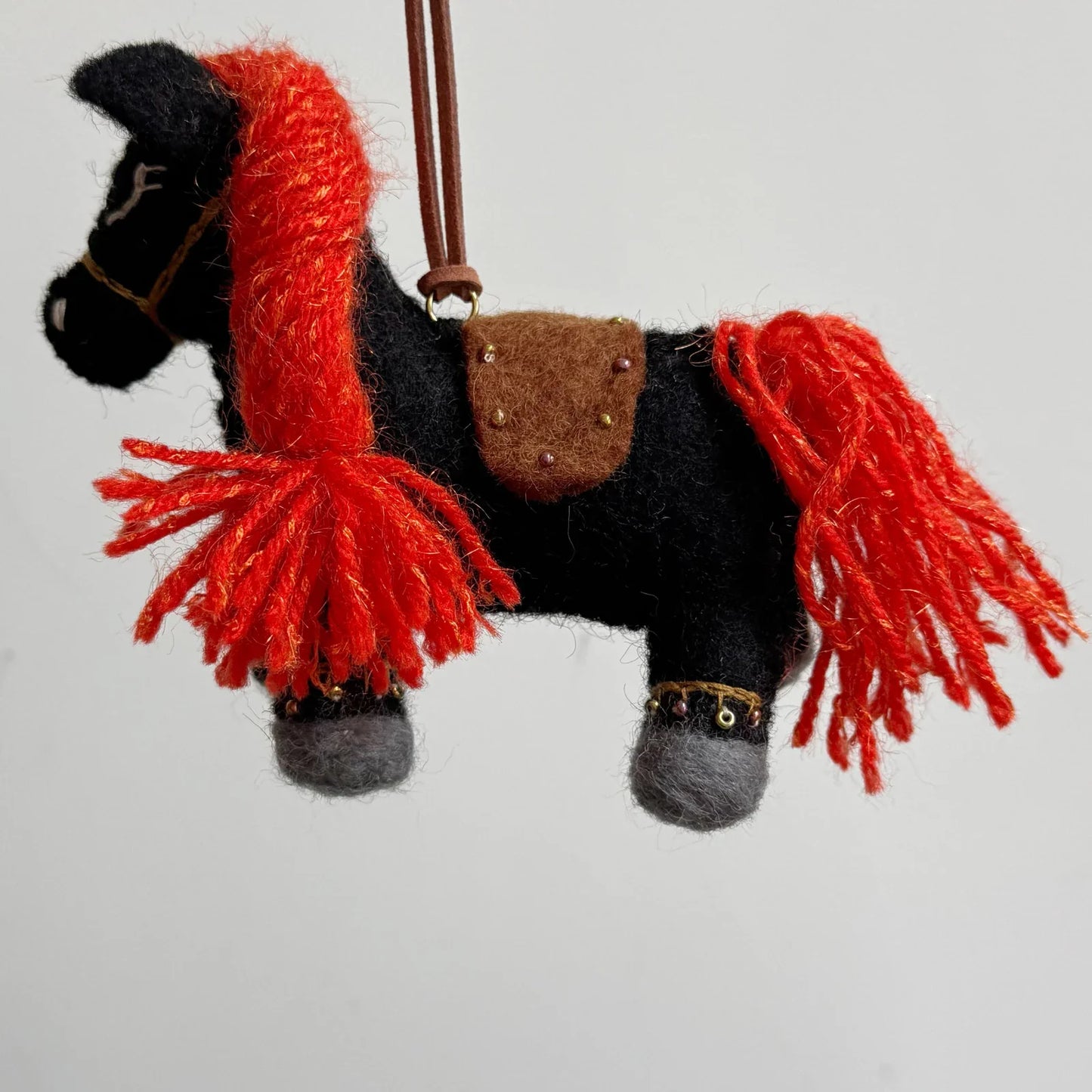 Black wool felt horse charm with red mane and leather rope loop