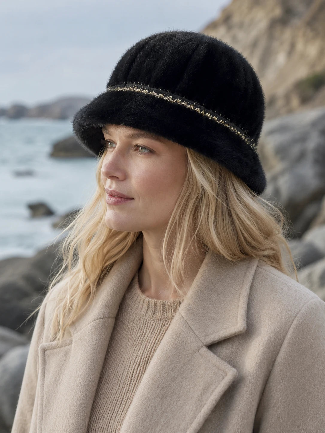 Woman wearing the Natural Black genuine mink fur bucket hat by the coast