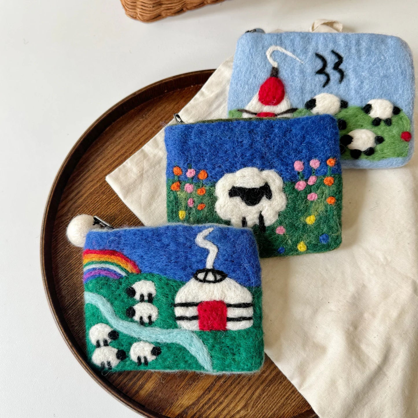Colorful handmade wool felt pouches in a home setting