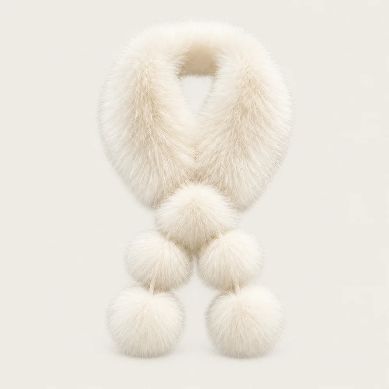 Ivory fox fur pom-pom scarf shown against a warm neutral studio background.