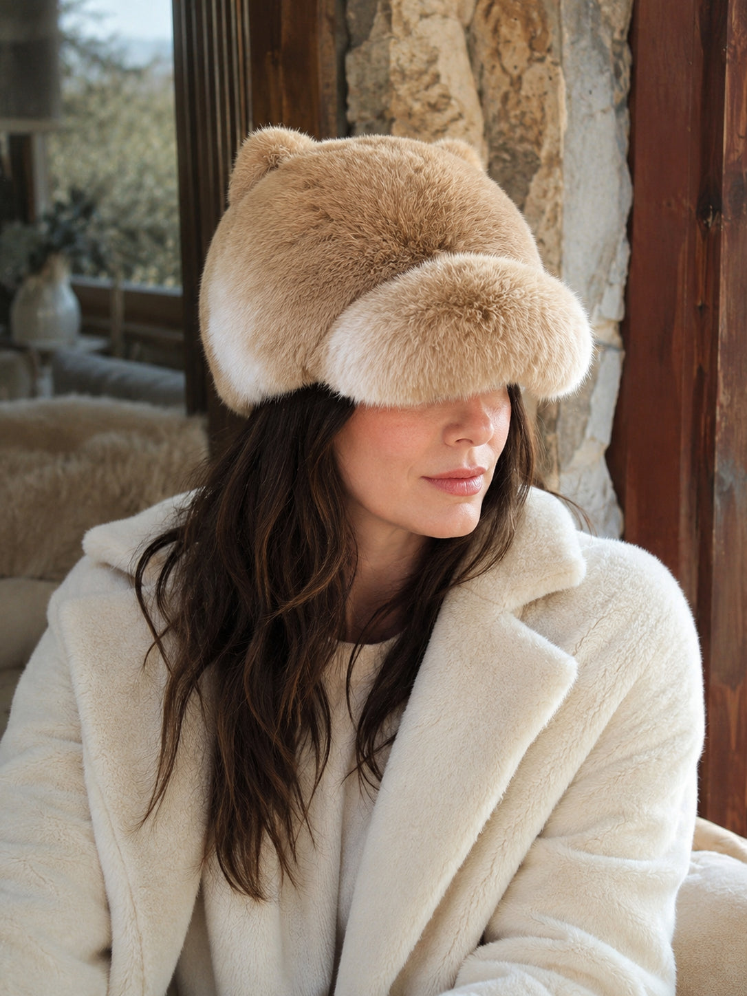 Woman wearing a Sunset Yellow rabbit fur cat-ear winter cap indoors