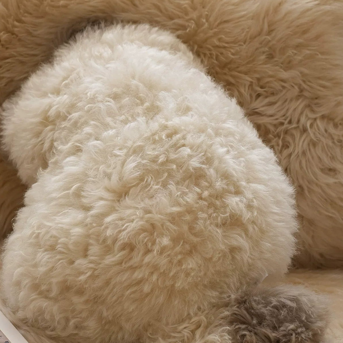 Close view of the cat-shaped cushion plush texture and contrasting tail
