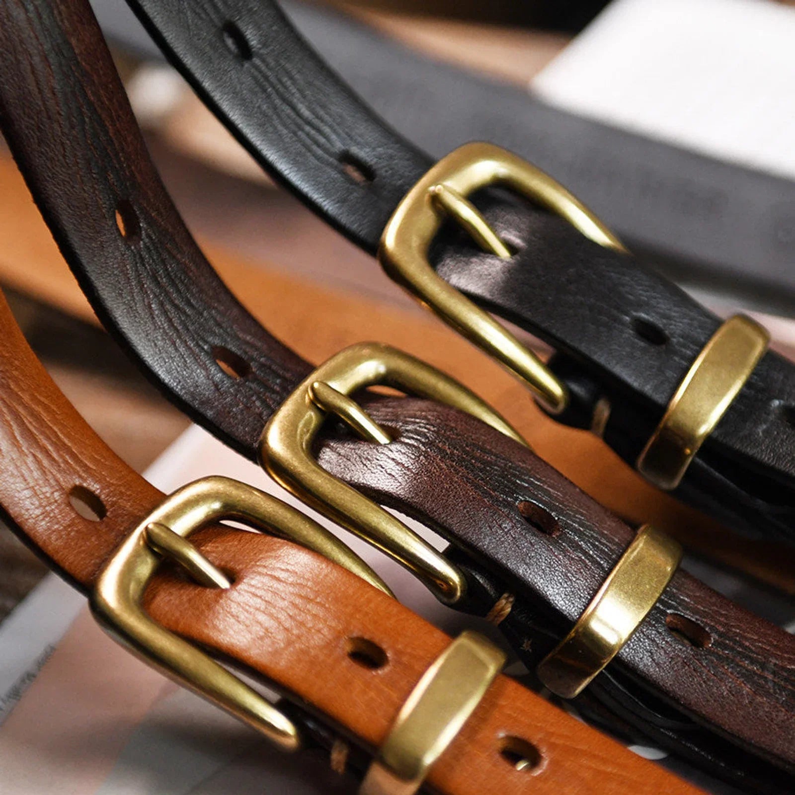 Black cognac and espresso leather belts with copper buckles