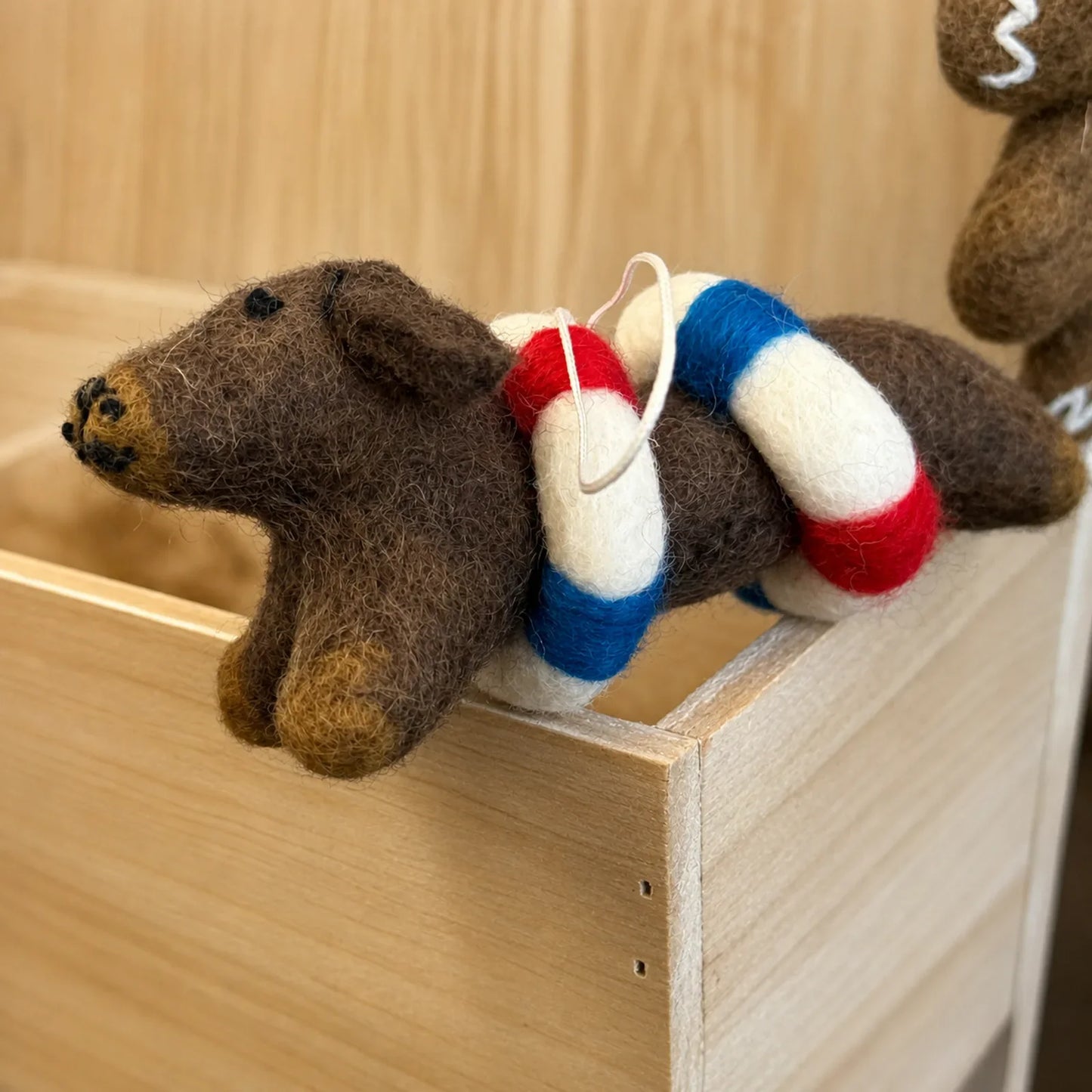 Dachshund wool felt ornament with a life ring detail