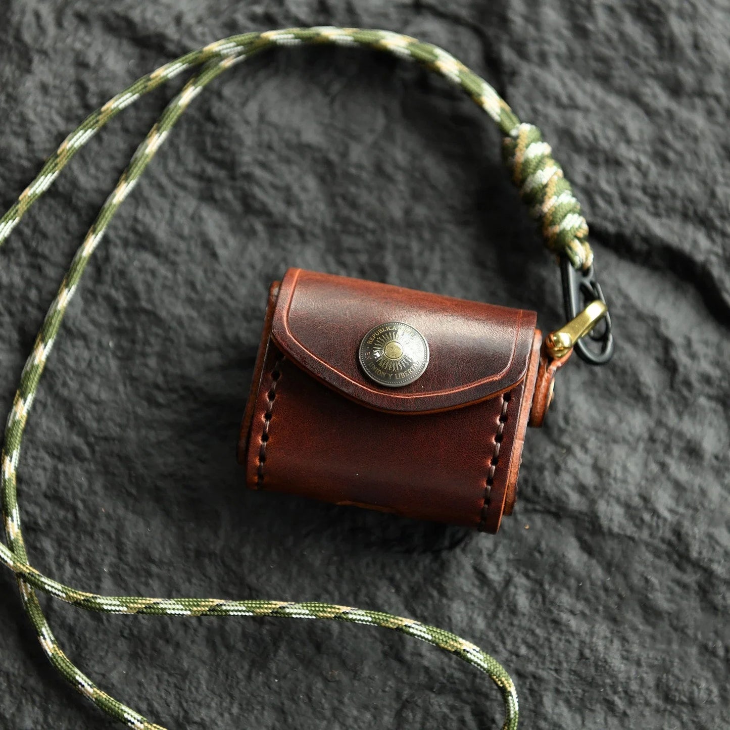 Deep Brown cowhide earbud case with sun medallion and neck cord