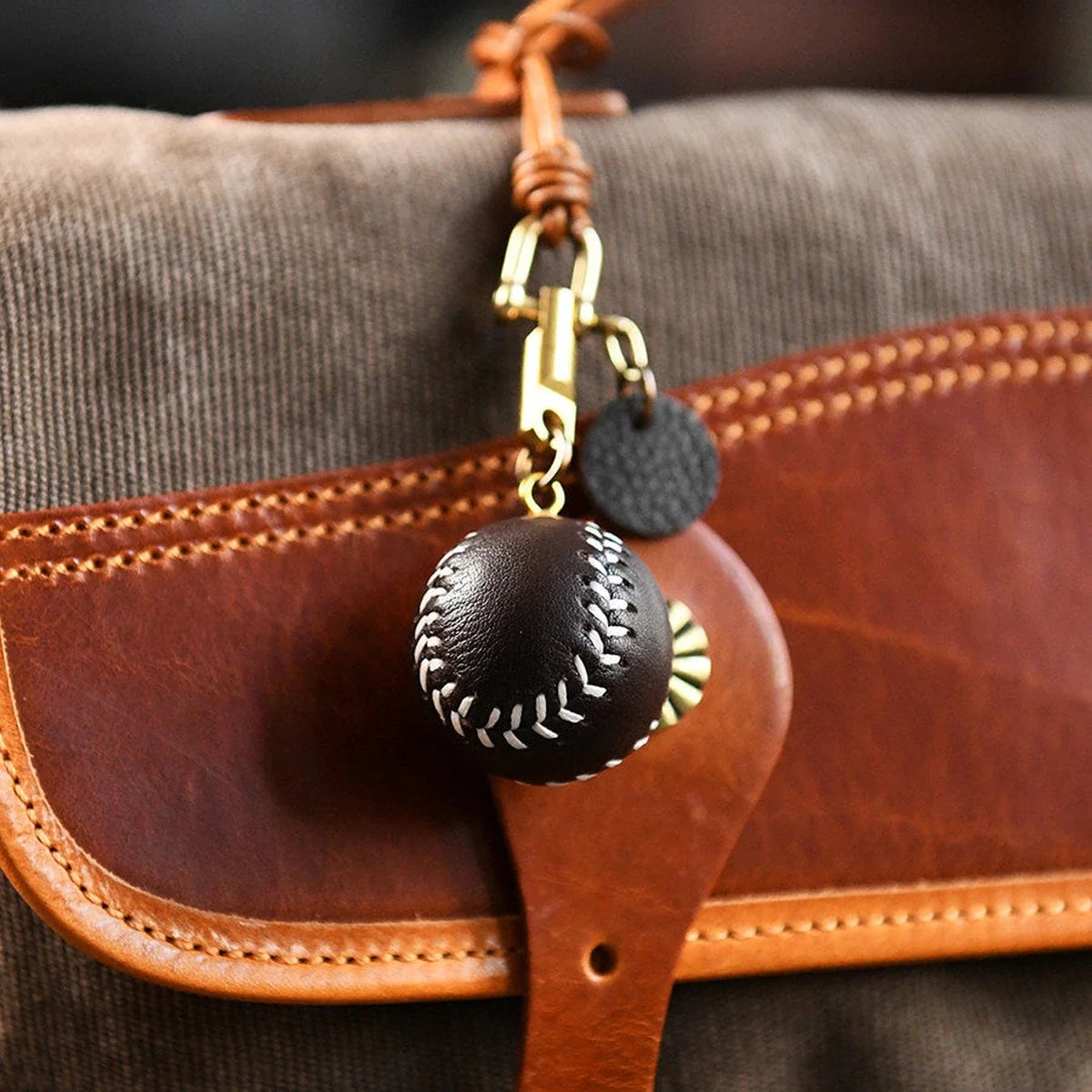Leather baseball keychain styled as a bag charm