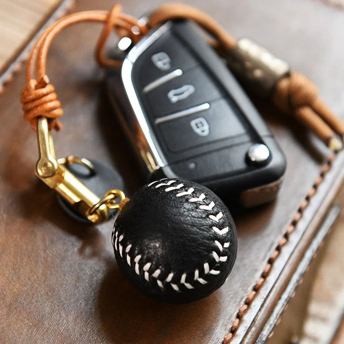 Hand-stitched leather baseball keychain with car key